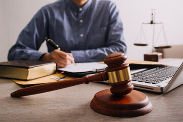 Male lawyer working with contract papers and wooden gavel on tabel in courtroom. justice and law ,attorney, court judge, concept.