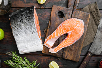 Salmon cut, on old dark  wooden table background, top view flat lay