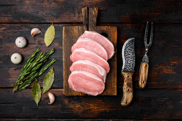 Pork meat. Fresh pork steaks, on old dark  wooden table background
