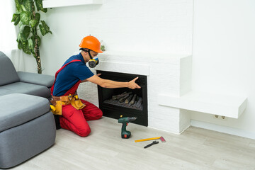Service technician working on a fireplace inside of a residential home