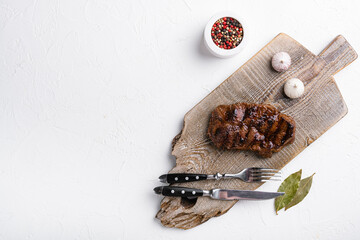Grilled beef meat steak with pepper sauce, on white stone table background, top view flat lay, with...
