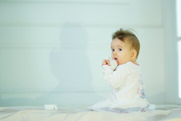 Fototapeta premium A small newborn baby is in a bright room. The concept of childhood