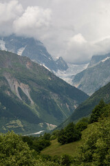 Panoramic view of the green and snowy mountains at the exit of the city of Mestia, during the trek to Ushguli, in Geogia. © Alberto