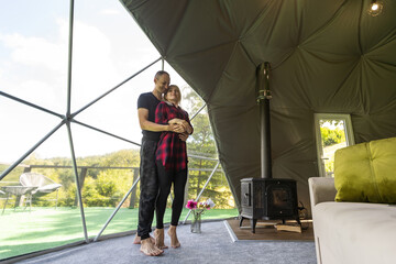 a couple dancing in geo dome tents.