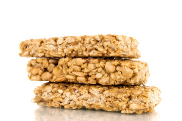 Three sweet roasted sweets from sunflower seeds and honey, macro, isolated on a white background.