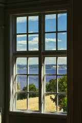 View through an old window towards Lake Mjøsa.
