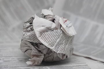 Crumpled newspaper on newspaper background, fake news, corrupt journalism, mass media and propaganda.