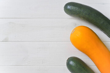 fresh whole zucchini green and yellow. White background.