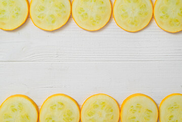 yellow zucchini sliced. White background.