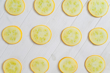 yellow zucchini sliced. White background.