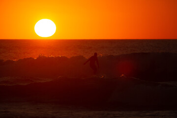 Fototapeta na wymiar Surf at sunset
