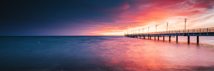 Amazing sunrise over the pier in Mechelinki - 522811149
