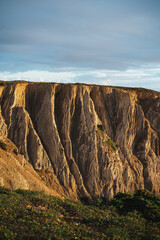 Beautiful cliff with lawn and plants during the sunset. It is in Algarve, Portugal.