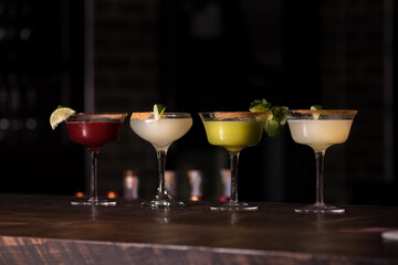 Four cocktails on a wooden table 