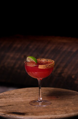 Red cocktail and lime garnish  