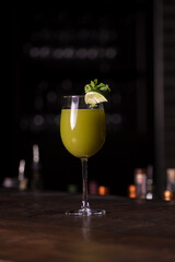 Green cocktail and lime garnish 