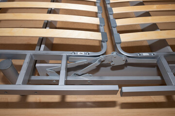 Lattice bottom, wooden slats and metal sofa folding mechanism close-up