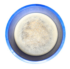 Surface of bubbles or lathers cover dirty water. in blue container isolated.