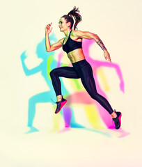 Sporty woman runner in silhouette. Photo of muscular woman in black sportswear on white background with effect of rgb colors shadows. Dynamic movement. Side view. Sport and healthy lifestyle