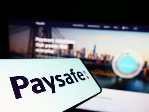 Stuttgart, Germany - 07-31-2022: Smartphone with logo of British payments company Paysafe Group on screen in front of business website. Focus on left of phone display.