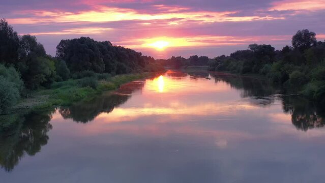 Beautiful aerial view video from a drone of Ukrainian nature - Seim river, morning sun in the mist on the river with trees and open spaces.