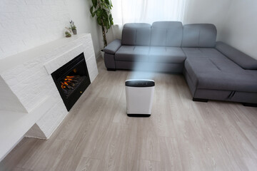 Air purifier in cozy white living room for filter and cleaning removing dust PM2.5 HEPA and virus in home, for fresh air and healthy Wellness life, Air Pollution Concept