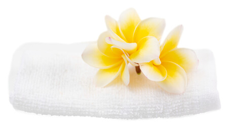 Naklejka na ściany i meble Beautiful frangipani flower set over white towel isolated on white with clipping path