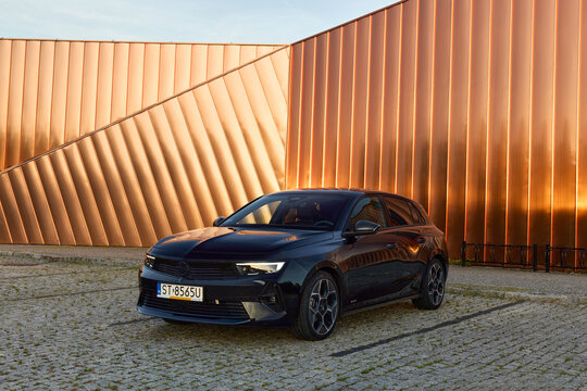 Black Opel Astra hatchback, parked  in front of the Fire Museum. Model 2022, sixth generation. 24.07.2022, Zory, Poland