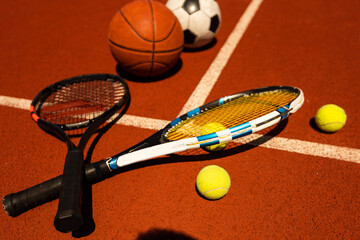 Set of sport equipment, rackets and tennis balls soccer and basketball balls