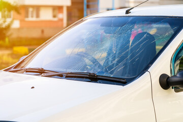 broken windshield of a car on a city street