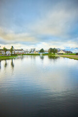 Agnew Park Stranraer pond at sunset with cloudscape and clear reflective water