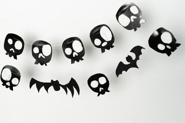 Bats and skulls black on white background, place to write greeting.