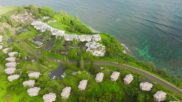 Aerial view of Hanalei Bay villas in Princeville town on Kauai north shore, Hawaii island, USA. Cinematic summer beach rental, vacation beach cottages for perfect summer vacation in paradise 4K drone