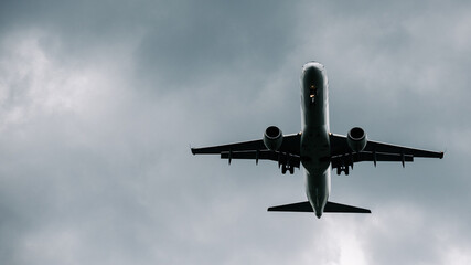 Passenger plane comes in for landing in cloudy weather.