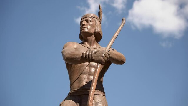 Close up of a statue of a native man 