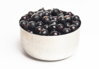 Black currants in a metal bowl