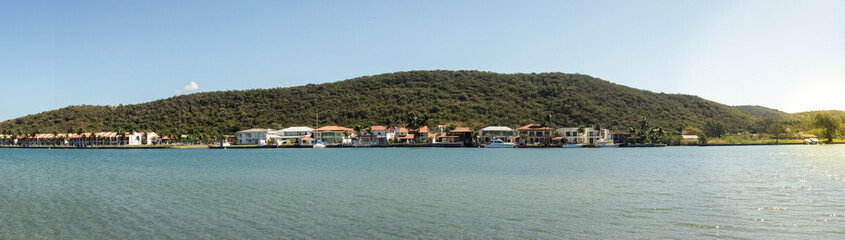 Fototapeta na wymiar bayfront mansion houses in condominium in a forested island. Panoramic