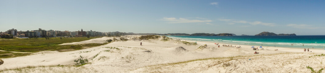 Sand dunes, buildings and sea in Forte beach. Cabo Frio, Rio de Janeiro, Brazil