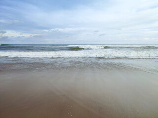 A view of sea beach near Jagannath Puri, golden sand, blue sky and water, a prominent tourist...