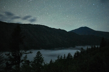 Night sky over the mountains of the Katunsky reserve in Altai