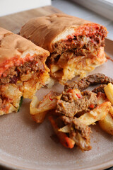 Masala steak Gatsby. South African cuisine. Roll filled with chips and masala steak