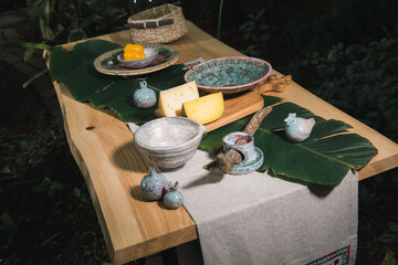 handmade wooden table and antique kitchen utensils, setting the dining table with ceramic dishes