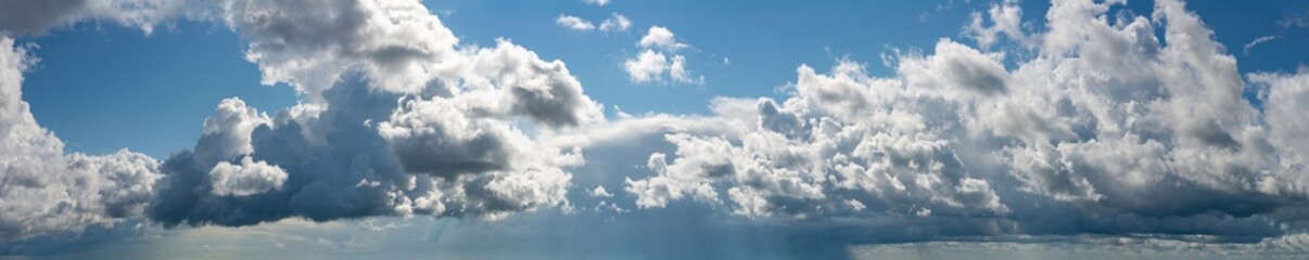 Fantastic clouds against blue sky, panorama