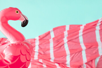 Summer beach composition. Inflatable mini flamingo on pastel blue background, pool float party,...