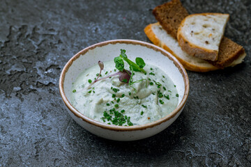 forshmak of herring with bread on dark stone table