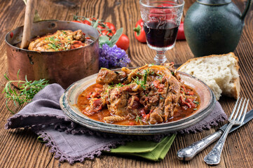 Traditional French poulet basquaise with chicken and vegetable ragout in red wine sauce served as...