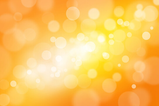 Abstract magic bokeh lights. Defocused lights on a yellow orange background.
