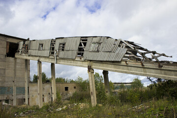 abandoned ruined building. concrete walls with broken windows and a lift, industrial buildings. victory of nature over industry and progress, devastation