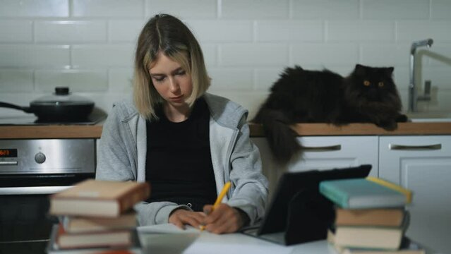 Teenage girl doing her schoolwork at home.