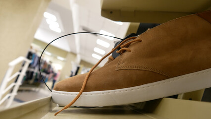 Close-up of new suede boots on the store shelf.